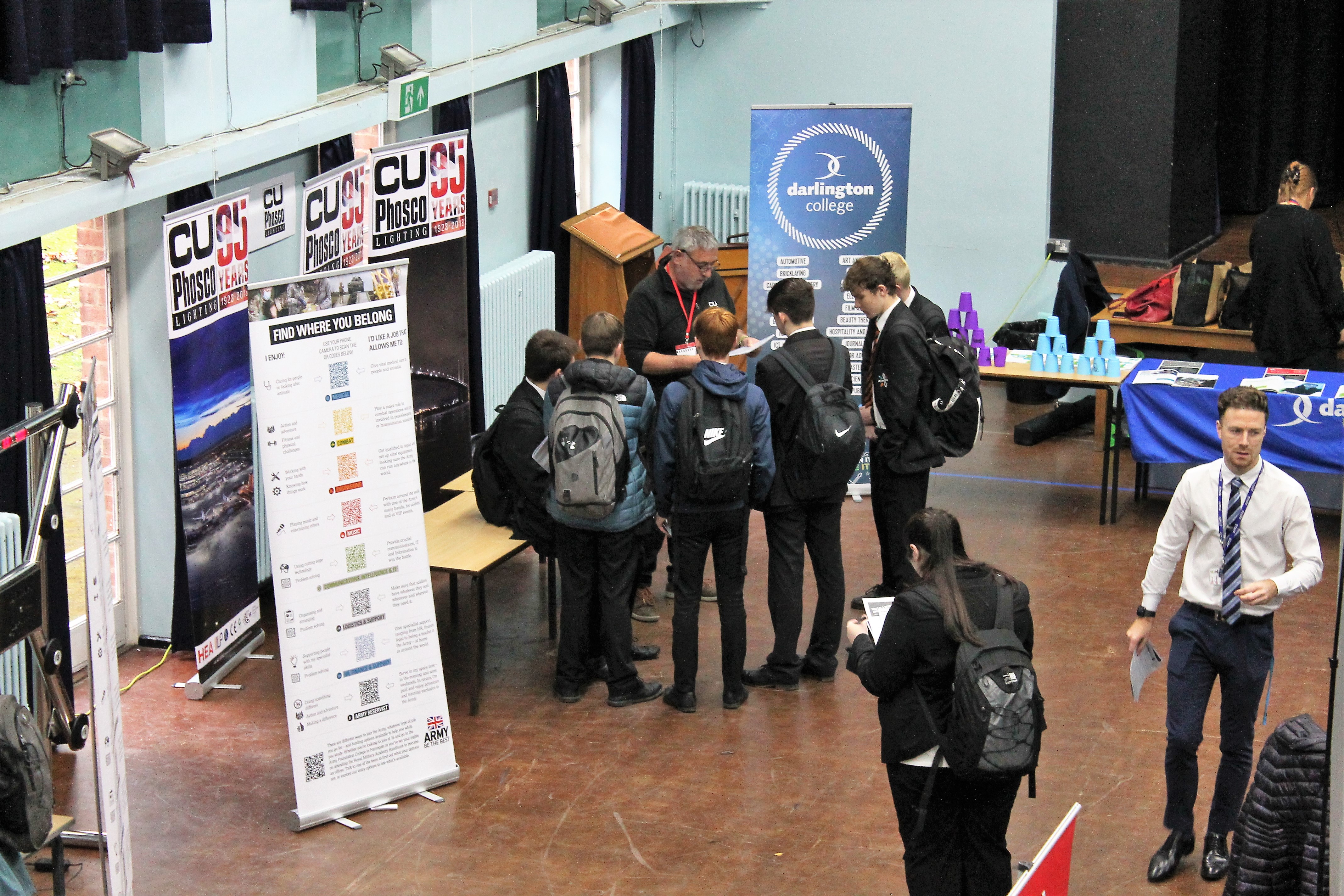 Pupils gathered around C U Phosco's stall engaged in conversation.