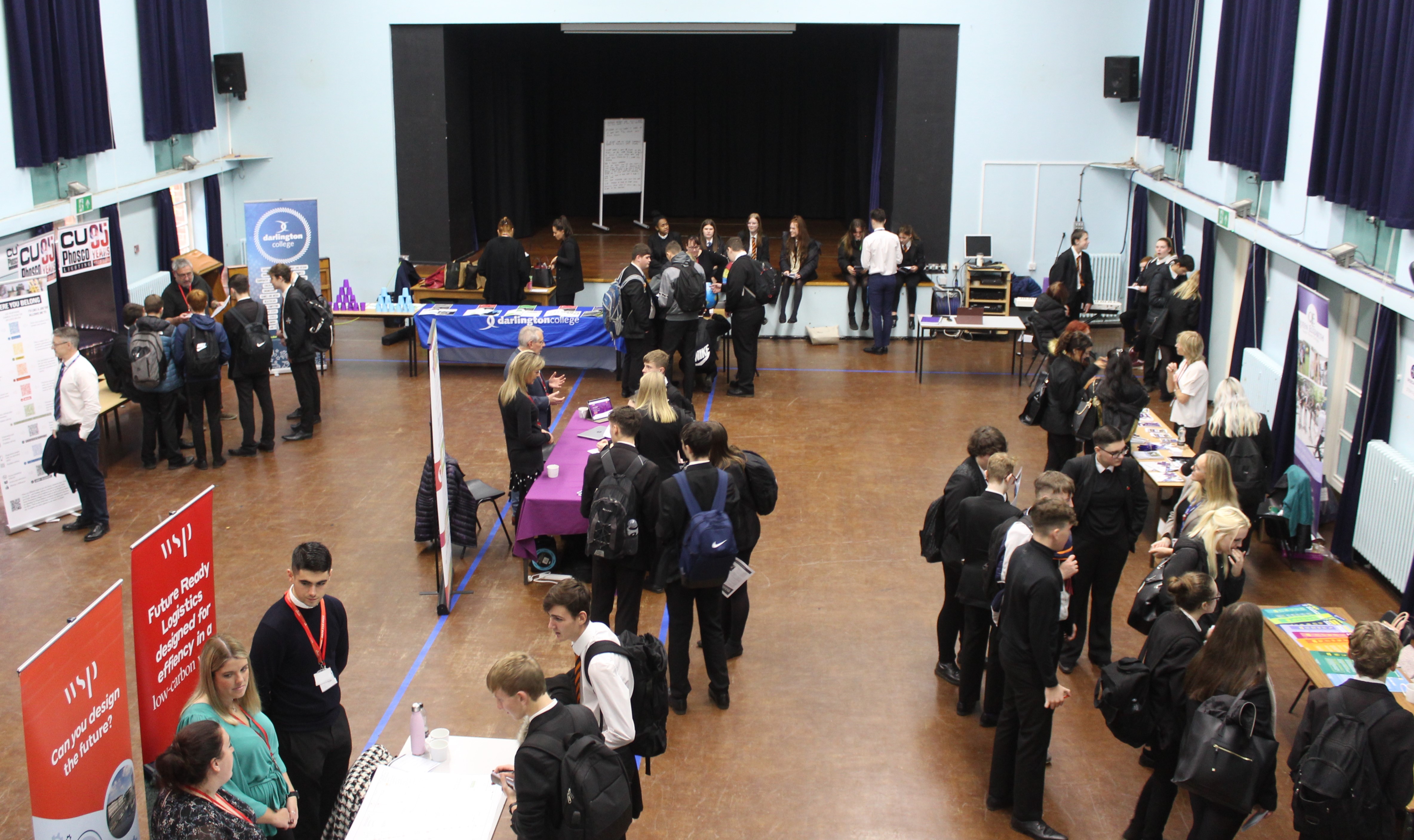 A photo of the hall and various company stalls.
