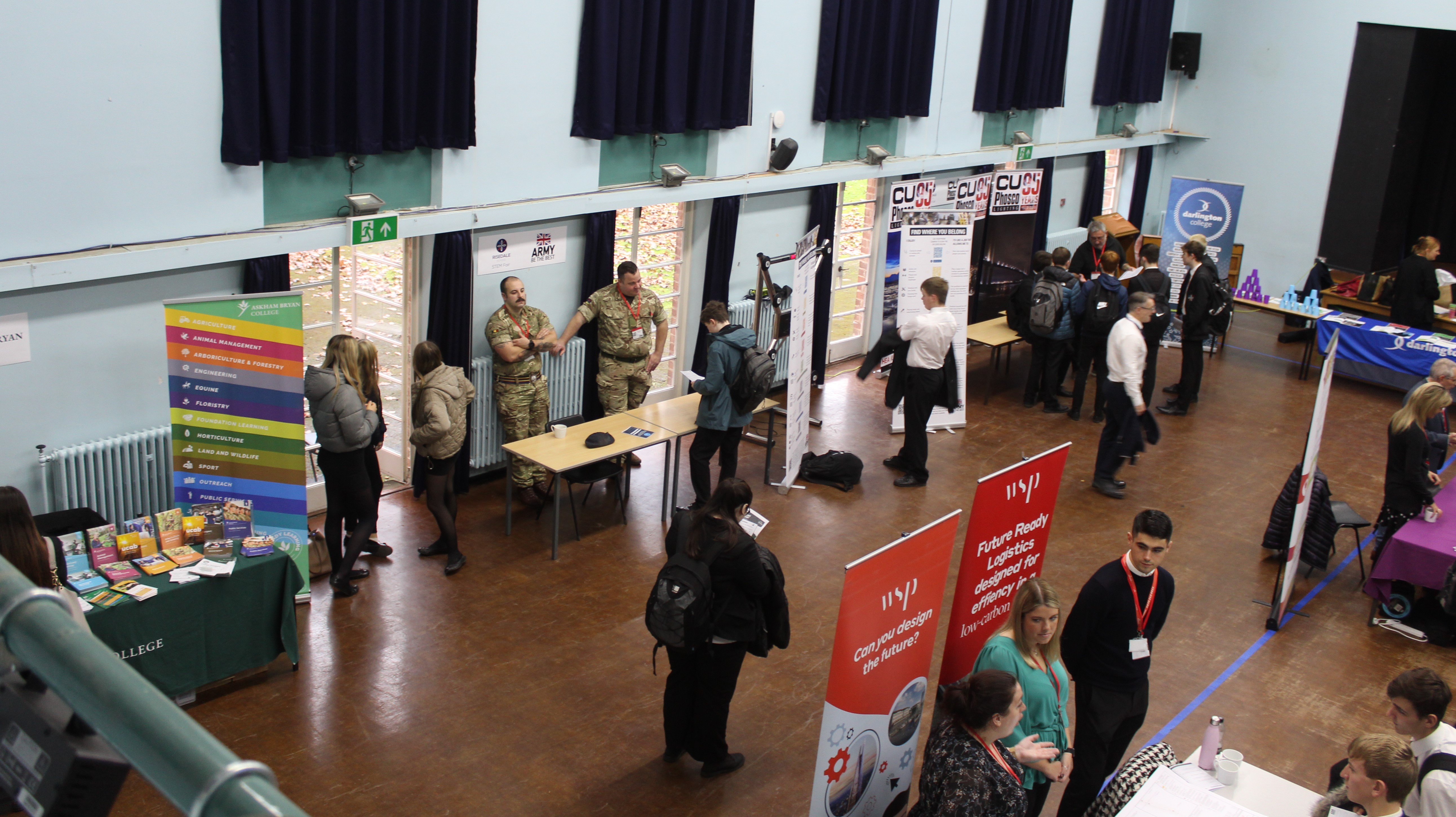 A photo of the hall and various company stalls.