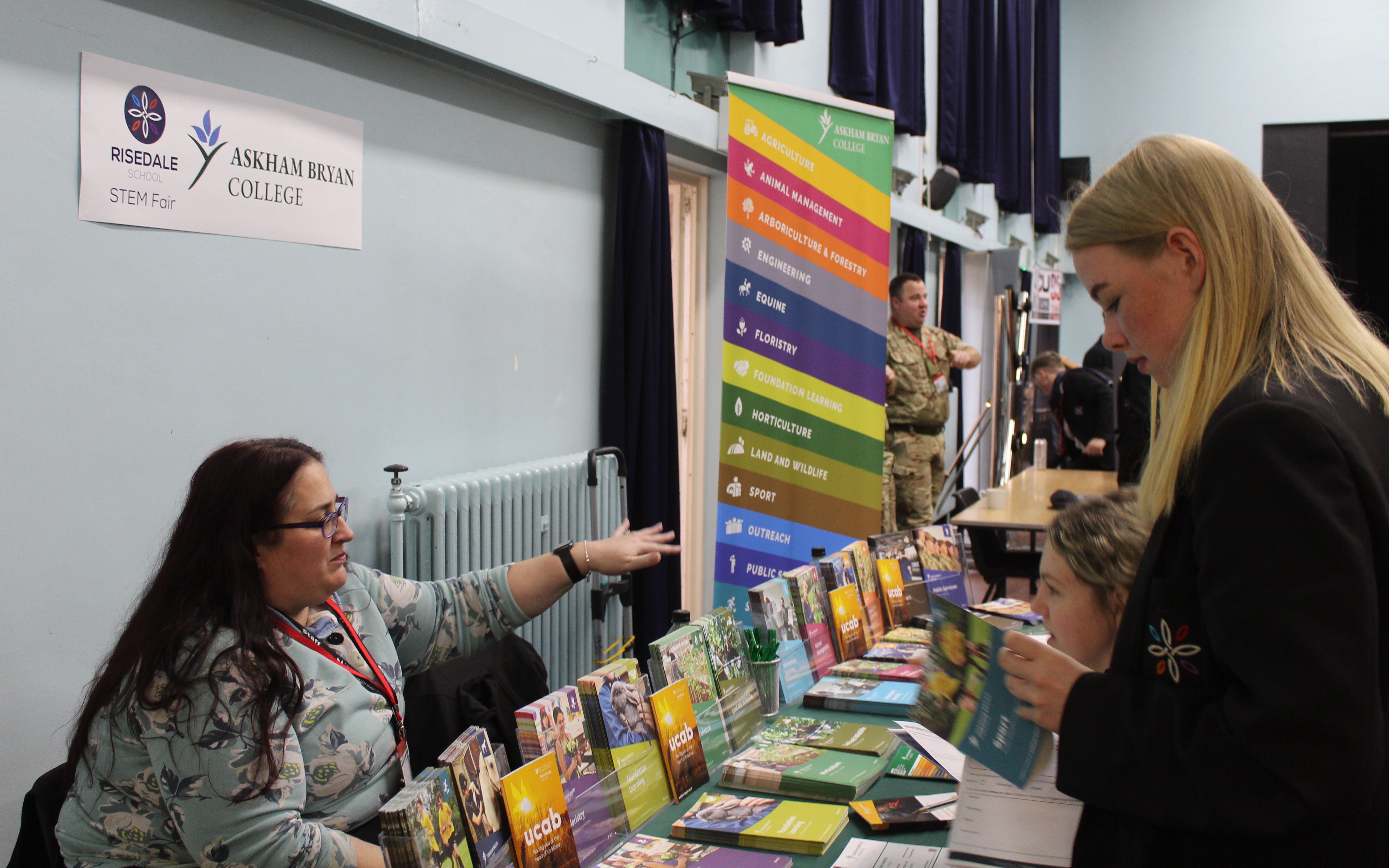 Pupils reading about courses available at Askham Bryan College.