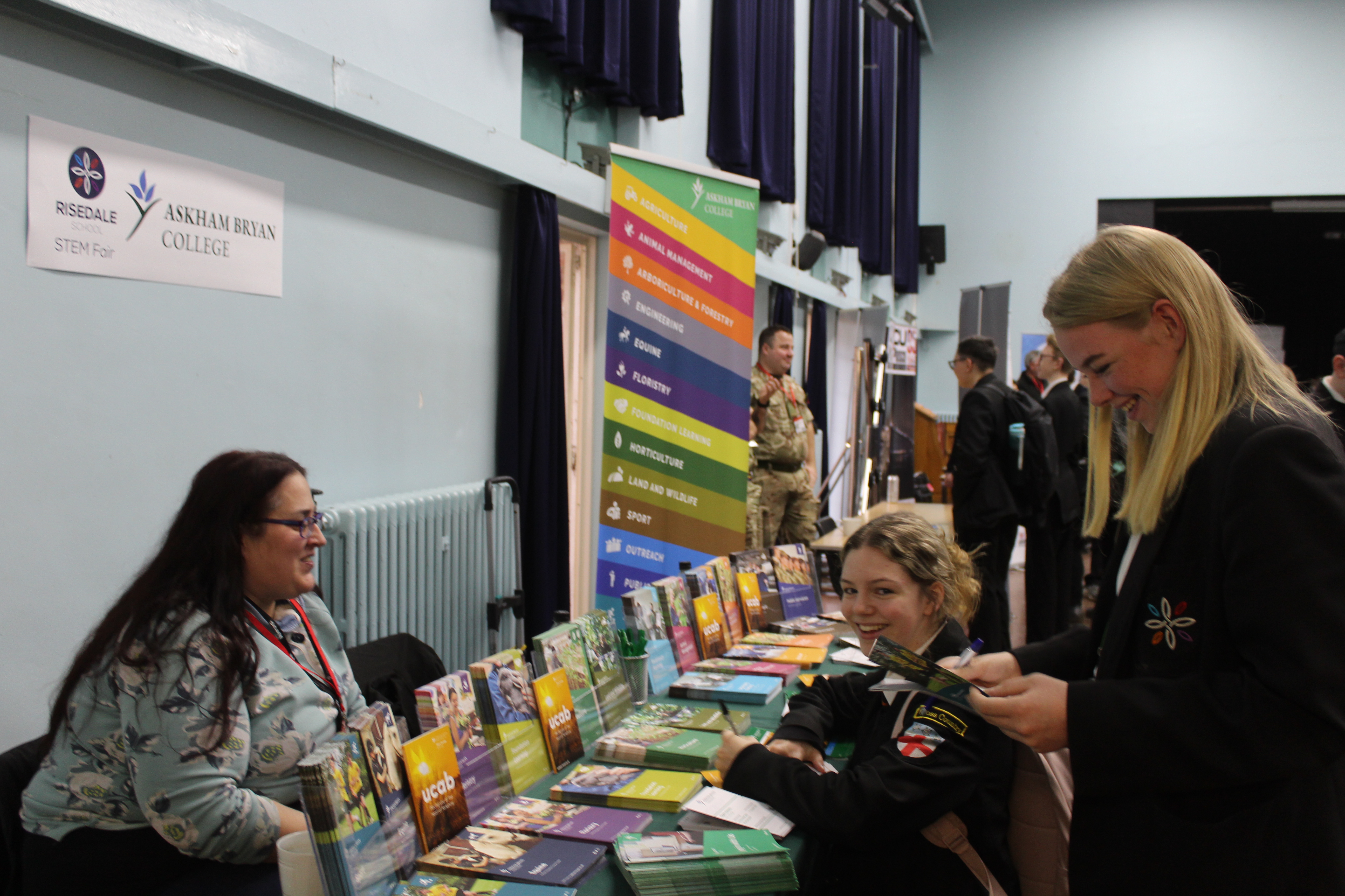 Pupils reading about courses available at Askham Bryan College.