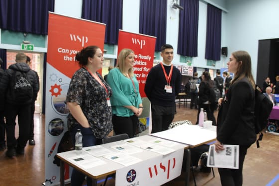 A year 8 pupil learning about WSP from Steph Deuchars, Abbey Walker, and Patrick Stockwell.