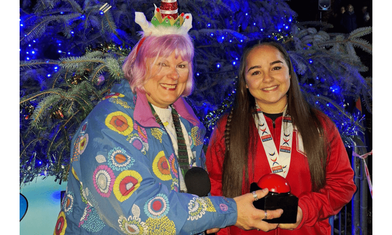 Gold Medalist Turns on Christmas Lights